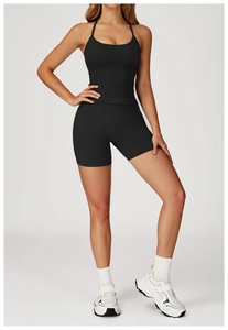 Close-up of seamless black yoga sports bra with cross-back straps and high-waisted shorts