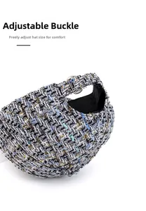 Close-up of the metal buckle on a tweed baseball cap showing the adjustable strap detail