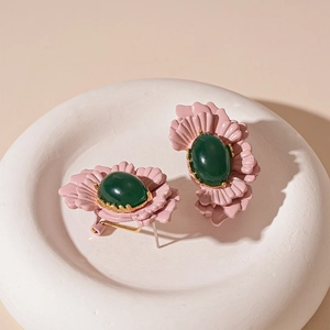 Vintage floral stud earrings with pink petals and green oval gemstone in gold setting