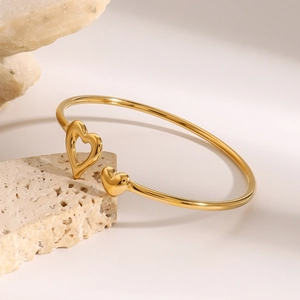 Polished 18K gold stainless steel open bangle with double heart motifs on stone base