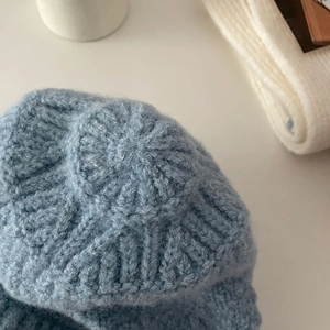 Detailed macro shot of soft blue knit texture and ribbed pattern on the wool scarf