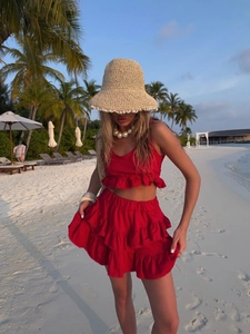 Detail of red tiered ruffled mini skirt and sleeveless crop top set for beach vacation