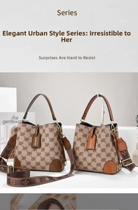 Detail view of stylish monogram bucket bags with leather trim and wide fabric shoulder straps