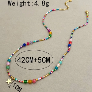 Colorful natural stone necklace with gold star pendant on a minimalist grey textured background