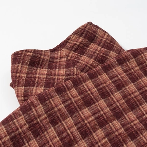 Close-up of high-quality brown and red plaid wool fabric texture with soft brushed finish