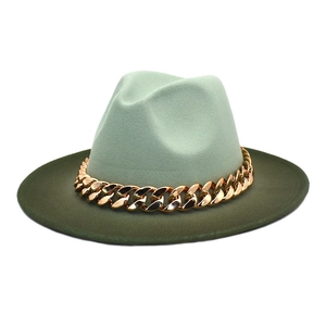 Detailed top view of mint and forest green wool fedora with a chunky gold chain