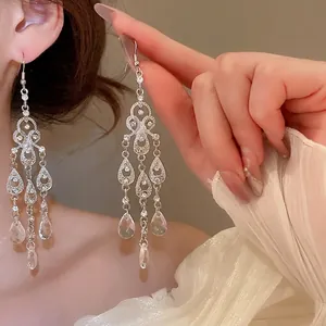Elegant water drop earrings with hollow diamond-set crystals and long tassel pendant