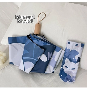 Macro detail of cute cat and leaf pattern folding umbrella with natural wooden handle