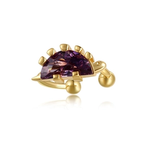 Macro detail of dinosaur spine gold ear cuff with polished 18K finish and purple gemstone