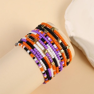 Detail of beaded star bracelets in orange and black on a display stand