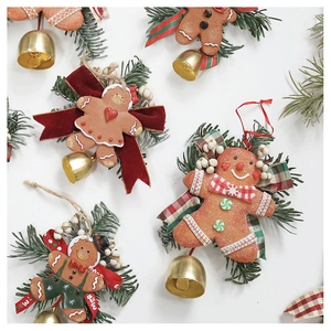 Detailed top view of gingerbread man Christmas ornaments with red bows and green pine needles