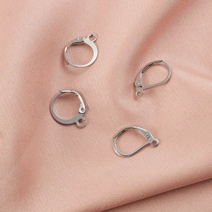 Polished silver stainless steel leverback earring hooks on a soft pink textured background