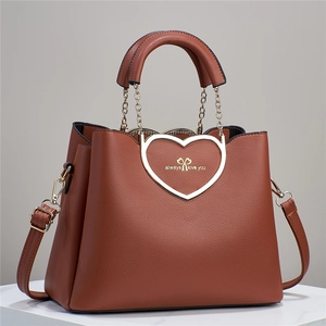 Detail of brown litchi grain tote bag with heart metal link and always love you text