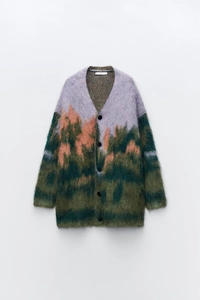 Close-up of the plush mohair texture and scenic landscape jacquard on this cardigan