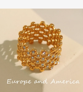 Close-up of golden honeycomb lattice ring with sparkling crystal pave setting