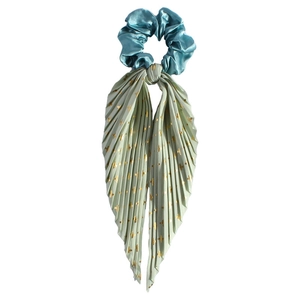 Detailed view of satin scrunchie with pleated ribbon featuring golden cross patterns