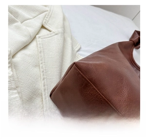 Detail view of vintage brown PU leather bag base featuring durable stitching and texture