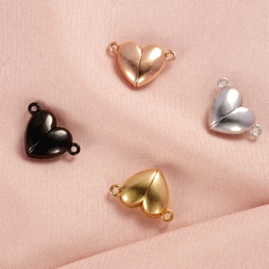 Four heart-shaped magnetic jewelry clasps in rose gold, silver, black, and gold metal finish