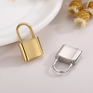 Gold and silver stainless steel padlock pendants for DIY jewelry on a clean fabric background