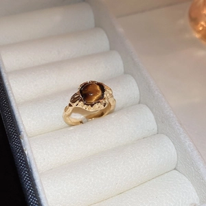 Detailed view of retro champagne gold ring with square tiger eye stone in jewelry box
