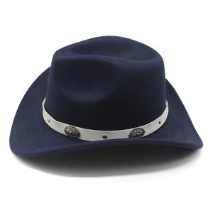 Detail of western cowboy hat featuring white band and vintage engraved metal buckles
