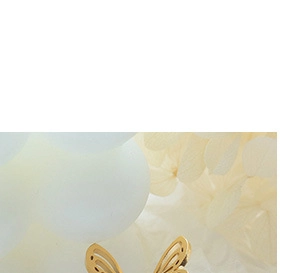 Macro detail of a hollowed butterfly pendant in 18K gold plated stainless steel