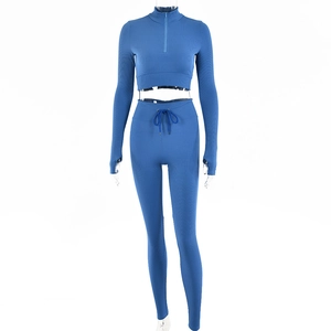 Detail of blue ribbed long sleeve crop top with half-zipper and high waist leggings