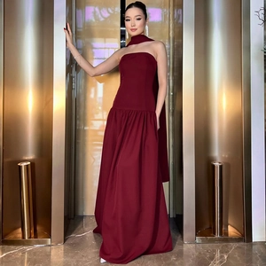 Detail of burgundy tube floor-length dress with matching neck scarf and fine texture