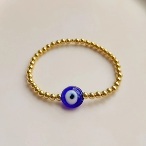 Ethnic 18K gold-plated beaded stretch bracelet featuring a blue Turkish Evil Eye charm