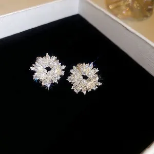 Sparkling silver flower stud earrings with zircon and pearls in a black jewelry box