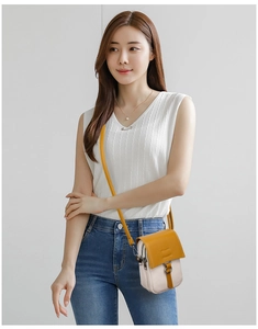 Detailed side view of ginger and beige vertical crossbody phone bag with metal D-ring buckle