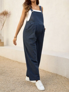 Close-up of blue and black checkered maternity jumpsuit with adjustable strap buckles
