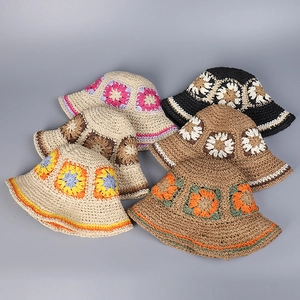 Flat lay of six handmade crochet bucket hats with colorful hollow floral patterns