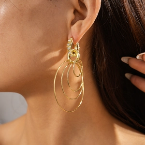 Detailed view of gold multi-layered geometric hoop earrings with sparkling rhinestones