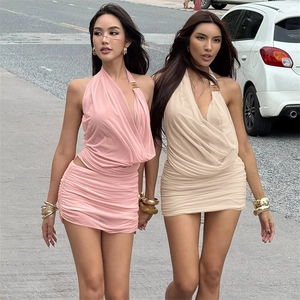 Street style detail of women's sexy halter neck bodycon dresses in pink and beige