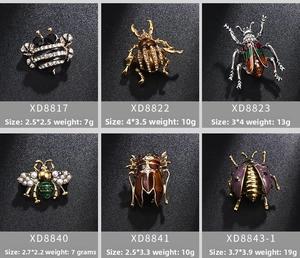 Detail view showing variety of insect brooches with rhinestones and enamel craft