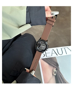 Close-up of neutral style quartz watch with brown silicone strap and black large dial