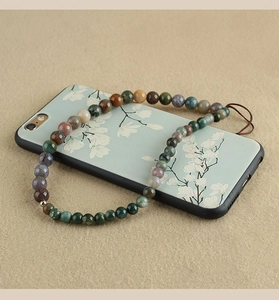Detail of handmade phone strap with turquoise, agate beads on an ethnic style phone case