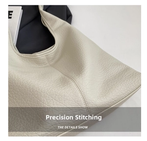 Detailed view of the off-white leather tote bag with reinforced double stitching