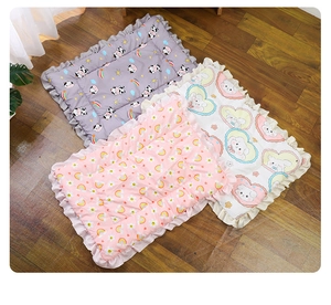 Three thickened pet mats with lucky happy prints and ruffle edges on wood floor
