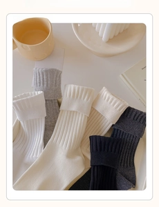 Close-up of ribbed cotton crew socks in neutral tones with high elasticity detail