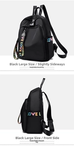 Detail view of large black oxford backpack featuring colorful LOVE printed strap accents