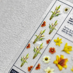 Self-adhesive nail art stickers featuring realistic yellow lilies and daisies on PET film