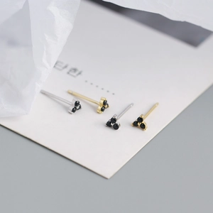 Detail of S925 sterling silver clover stud earrings set with black stones in gold and silver