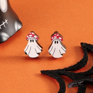 Macro detail of cartoon ghost stud earrings with red mushroom hats for Halloween style