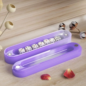 Purple magnetic dice storage box with 7 dice on a wooden table with rose petals