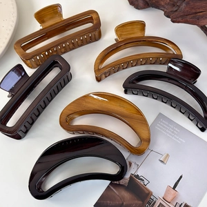 French vintage acetate hair claws in amber and tortoiseshell crescent moon shapes