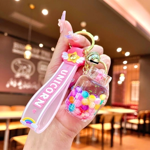 Close-up of pink unicorn keychain with colorful beads in a liquid sand bottle detail