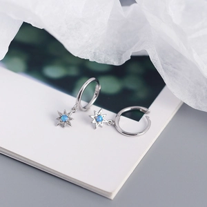 Macro view of S925 silver octagonal star earrings featuring blue opal stones