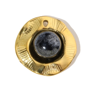 Macro detail of a golden sunburst pendant with a round dark gemstone inlay for DIY jewelry